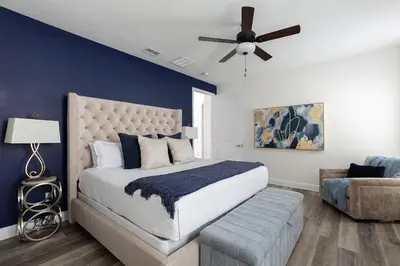 a bedroom with a bed and a ceiling fan at Unleash Your Dreams in a Magical Getaway in Orlando