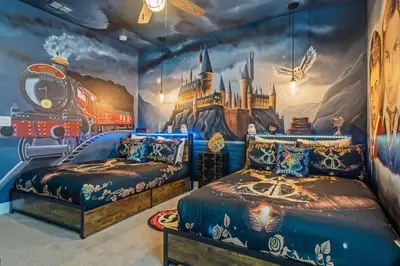 a bedroom with two beds and a train mural at Experience Magic and Luxury Just Minutes from Disney in Orlando
