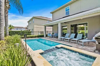 a swimming pool in the backyard of a house at Experience Magic and Luxury Just Minutes from Disney in Orlando