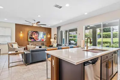 a kitchen and living room with a couch at Experience Magic and Luxury Just Minutes from Disney in Orlando
