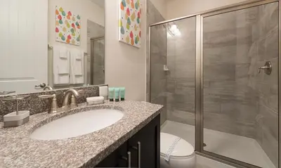 a bathroom with a sink and a shower at Dive into Luxury and Fun at Your Orlando Paradise in Orlando