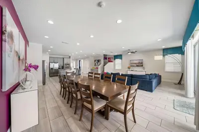 a dining room and living room with a table and chairs at Indulge in Opulence: Where Comfort Meets Endless Fun in Orlando