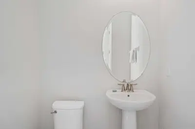 a white bathroom with a sink and a mirror at Indulge in Opulence: Where Comfort Meets Endless Fun in Orlando
