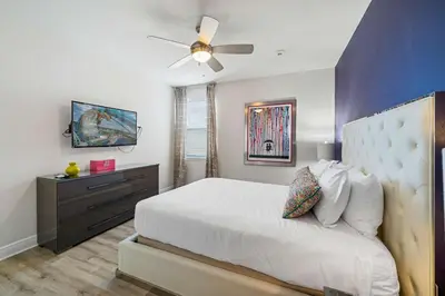 a bedroom with a bed and a ceiling fan at Indulge in Opulence: Where Comfort Meets Endless Fun in Orlando