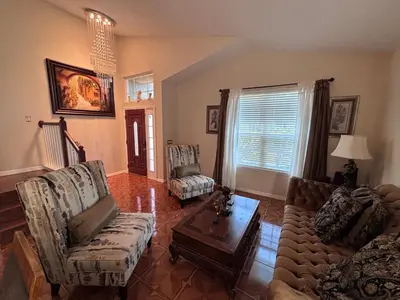 a living room with a couch and a table at Luxury Apartment with Lake view in Orlando