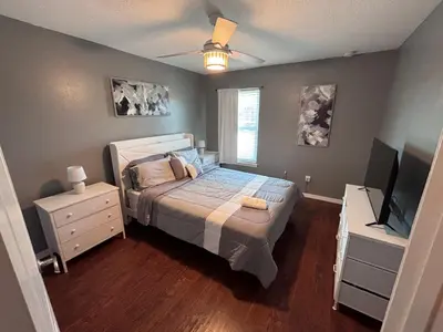 a bedroom with a bed and a flat screen tv at Luxury Apartment with Lake view in Orlando