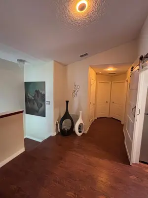 a room with a hallway with a vase on the floor at Luxury Apartment with Lake view in Orlando