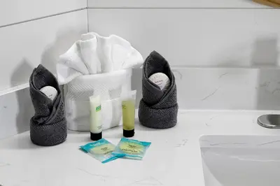a pair of shoes and towels on a counter in a bathroom at The Perch-2 Miles from Disney, Movie Theatre & Water Park in Orlando
