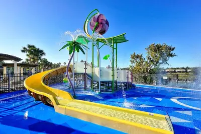 a pool with a water slide at a resort at The Perch-2 Miles from Disney, Movie Theatre & Water Park in Orlando