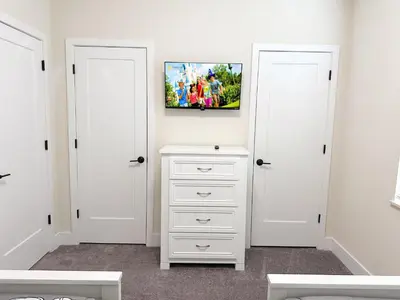 a bedroom with two white doors and a painting on the wall at TR1461SL - 4 bedrooms pool home - 10 guests in Orlando