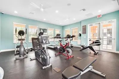 a gym with several exercise equipment in a room at TR1461SL - 4 bedrooms pool home - 10 guests in Orlando