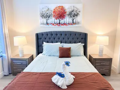 a bedroom with a bed with a swan on it at TR1391 – 4 Bedrooms Home with pool near Disney in Clermont