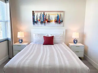 a bedroom with a large bed with two lamps at TR1391 – 4 Bedrooms Home with pool near Disney in Clermont