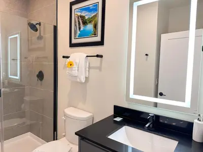 a bathroom with a toilet and a sink and a shower at TR1391 – 4 Bedrooms Home with pool near Disney in Clermont