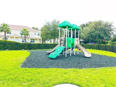 a playground with a slide in a park at TR1391 – 4 Bedrooms Home with pool near Disney in Clermont