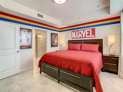 a bedroom with a red bed with a marvel sign on the wall at Beautiful 3bed 2bath Condo close to Disney Parks 344 in Kissimmee