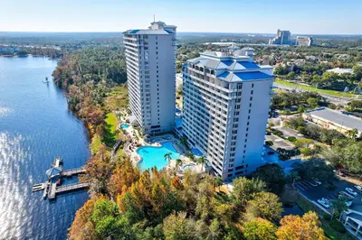 an aerial view of two tall buildings next to a river at LUXURY 1br LAKEVIEW CONDO NEAR DISNEY! in Orlando