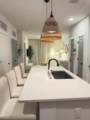 a kitchen with a white counter and a sink at Modern 1 bedroom Apartment and Den in Orlando in Orlando