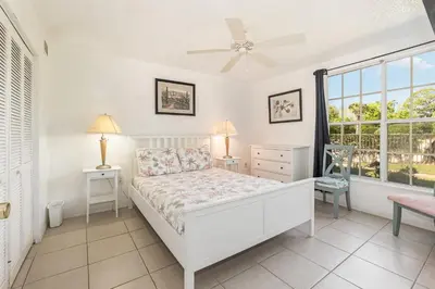 a white bedroom with a bed and a window at Family Home w/ Pool & Water Views, Near Disney in Kissimmee