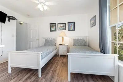 a bedroom with two beds and a window at Family Home w/ Pool & Water Views, Near Disney in Kissimmee