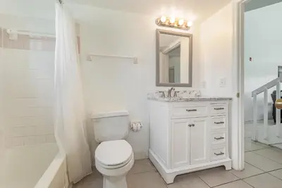 a bathroom with a toilet and a sink and a shower at Family Home w/ Pool & Water Views, Near Disney in Kissimmee