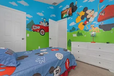 a bedroom with a mickey mouse mural on the wall at Windsor Hills Home with Pool & Near Disney in Orlando