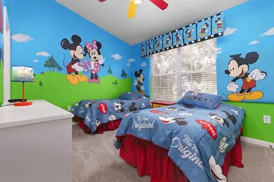 two beds in a bedroom with mickey mouse mural at Windsor Hills Home with Pool & Near Disney in Orlando