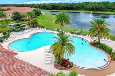an overhead view of a large swimming pool with palm trees at Oakwater Resort Home w/ Arcade & Pool Table - 15 Min to Disney in Orlando