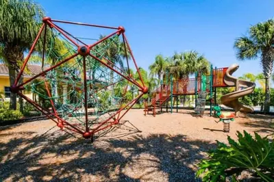 a playground with a slide in a park at Oakwater Resort Home w/ Arcade & Pool Table - 15 Min to Disney in Orlando