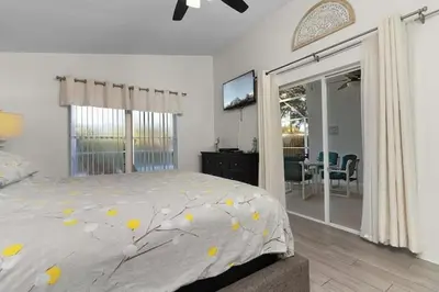 a bedroom with a bed with yellow flowers on it at Indian Ridge Home w/ Private Pool & Game Room near Disney in Orlando