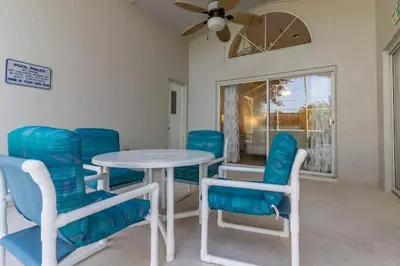 a dining room with blue chairs and a table at Indian Ridge Home w/ Private Pool & Game Room near Disney in Orlando