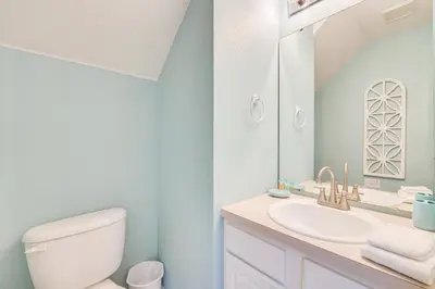 a bathroom with a white toilet and a sink at 3 Mi to Disney Family-Friendly Home! in Orlando