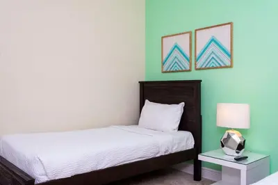 a bedroom with a bed and a table with a lamp at 421 NP - Exquisite Retreat at Encore Resort in Orlando