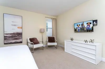 a bedroom with a white bed and a dresser at 421 NP - Exquisite Retreat at Encore Resort in Orlando