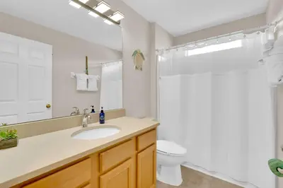 a bathroom with a sink and a toilet and a shower at Stunning Emerald Island Resort Vacation Home with Pool Spa and Access to Clubhouse in Kissimmee