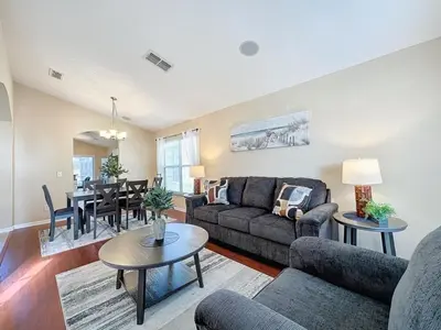 a living room with a couch and a table at Emerald Island Four Bed Pool Home close to Disney villa in Kissimmee