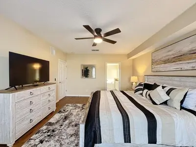 a bedroom with a bed and a ceiling fan at Emerald Island Four Bed Pool Home close to Disney villa in Kissimmee