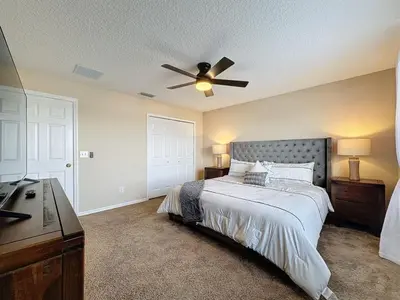 a bedroom with a bed and a ceiling fan at Emerald Island Four Bed Pool Home close to Disney villa in Kissimmee