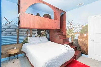 a bedroom with a bed with a painting on the wall at Fantastic Home 7BR5BA with Private Pool Storey Lake Resort SL2648 in Kissimmee