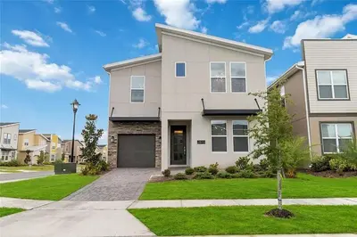 a large white house with a driveway at Fantastic Home 7BR5BA with Private Pool Storey Lake Resort SL2648 in Kissimmee