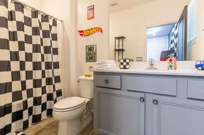 a bathroom with a toilet and a sink and a shower at Disney Dream House com 12 Themed Bedrooms 5851 in Orlando