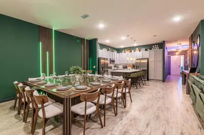 a dining room with a long table and chairs at Disney Dream House com 12 Themed Bedrooms 5851 in Orlando