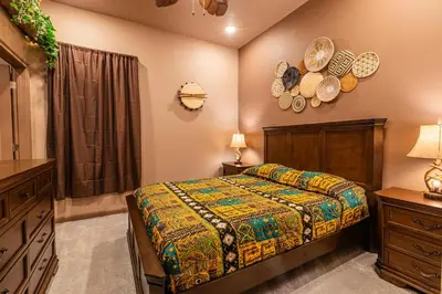 a bedroom with a bed and a dresser and a window at Disney Dream House com 12 Themed Bedrooms 5851 in Orlando