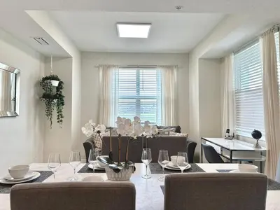 a dining room with a table and chairs at 2 Bedroom Condo minutes from Disney 325 in Kissimmee