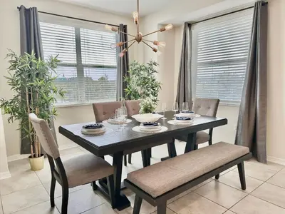 a dining room with a black table and chairs at My condo 2bd 2bth close to Disney World 315 in Kissimmee