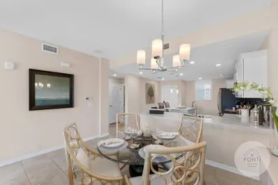 a dining room and kitchen with a table and chairs at 3141-104 Resort Lake View Disney Universal Orlando in Kissimmee