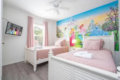 two beds in a childs bedroom with a disney mural at 4 bedrooms close to Disney in Kissimmee