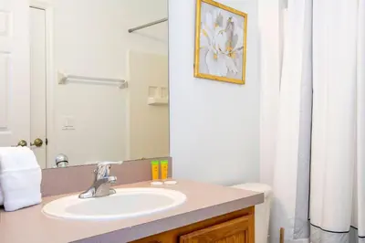 a bathroom with a sink and a mirror at 4 bedrooms close to Disney in Kissimmee
