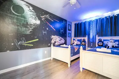 a childs bedroom with two twin beds and a space mural at 4 bedrooms close to Disney in Kissimmee