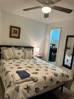 a bedroom with a bed and a ceiling fan at Private Studio in Kissimmee